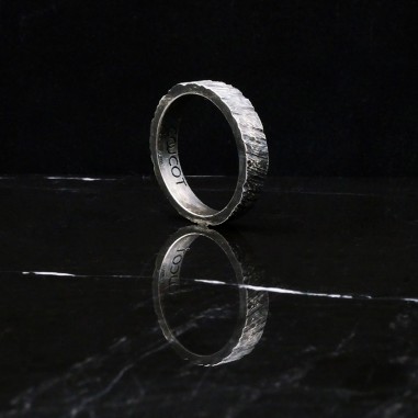 Photo sur fond marbre noir de l’alliance homme en argent modèle Tungstène finition vieillie vue trois quart.
